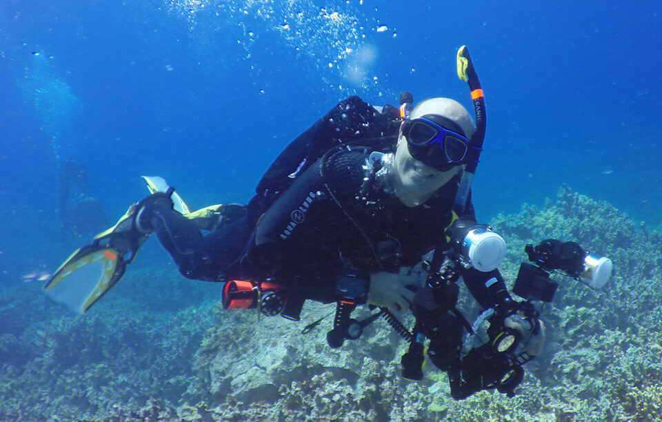 Randall Spangler scuba diving with camera
